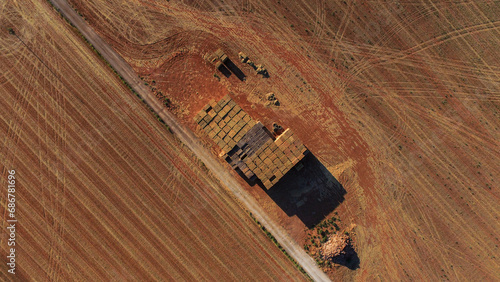 overhead view of a mountain of straw blocks next to a rurak road photo
