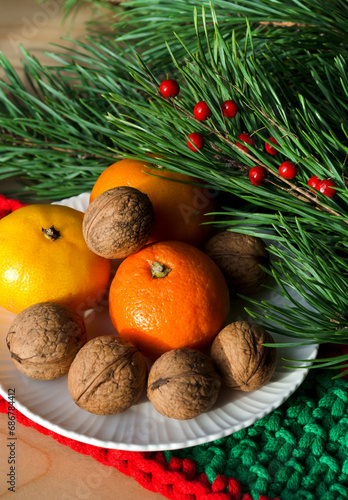 Tangerines and walnuts on a New Year's background.