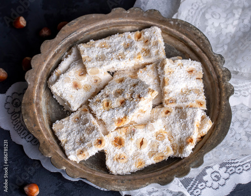 Traditional delicious Turkish dessert; cezerye with hazelnuts and coconut (Turkish name; Findikli madonna) photo