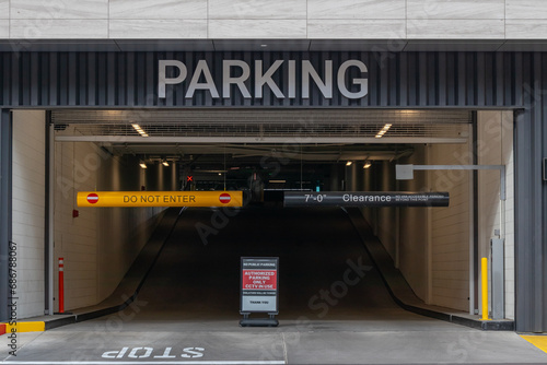Entrance to parking garage structure with height warning sign photo