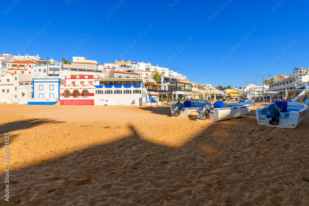 The picturesque seaside, whitewashed fishing village of Carvoeiro Portugal, along the Algarve coastline region of southern Portugal.
