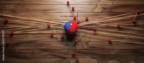 North Korea flag on a pushpin illustrates global economic influence on a wooden map Travel and logistics concept Network Copy space image Place for adding text or design photo