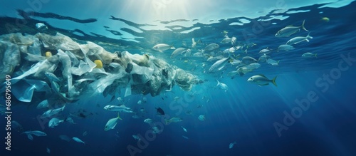 Plastic pollution in the ocean caused by single use plastic and fish in a shallow reef Copy space image Place for adding text or design photo