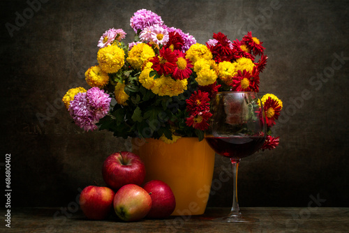 Still life with a bouquet of chrysanthemums, apples and a glass of wine