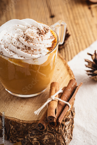 Fotografija Pumpkin spice latte with whipped cream and cinnamon, warmer autumn and winter ho