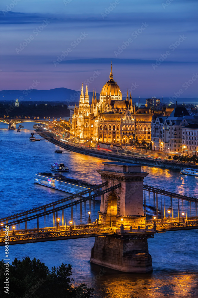 Hungary, Budapest, tranquil evening in the city with lit up Hungarian Parliament and Chain Bridge on Danube River