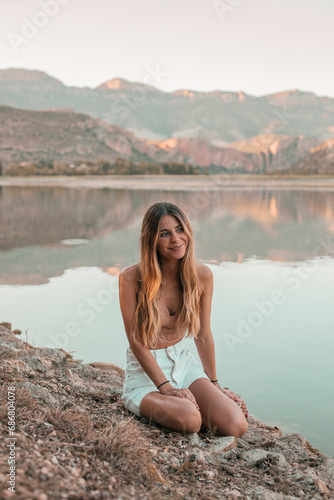 Young blond woman at a lake © tunedin