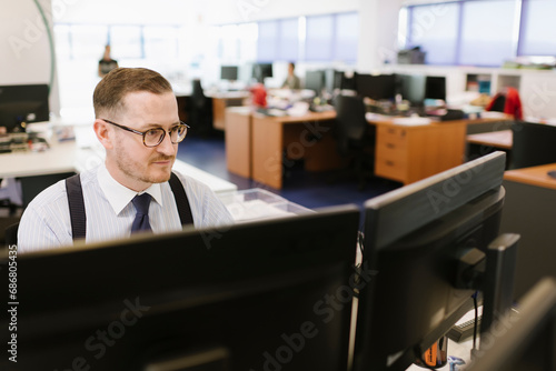 Businessman using computer at desk in office