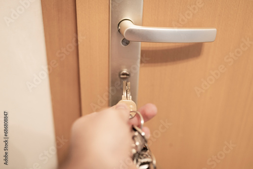 Germany, Hand of man locking home door photo