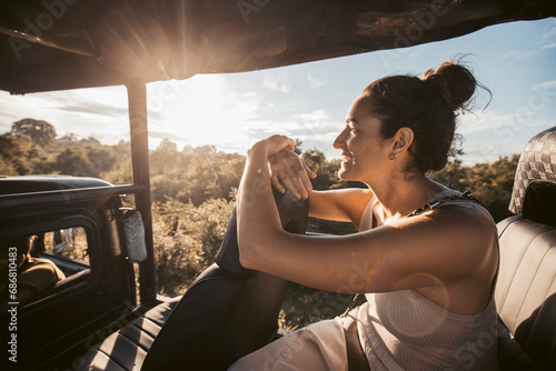 Sri Lanka, Sabaragamuwa Province, Udawalawe, portrait of adult woman sitting in car during safari inUdawalawe National Park at sunrise photo