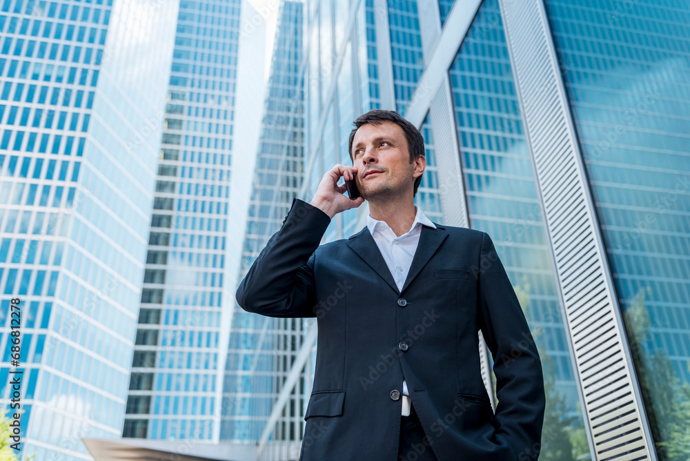 Businessman on cell phone in the city