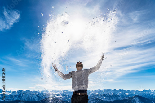 Germany  Bavaria  Brauneck  man in winter playing with snow in the mountains