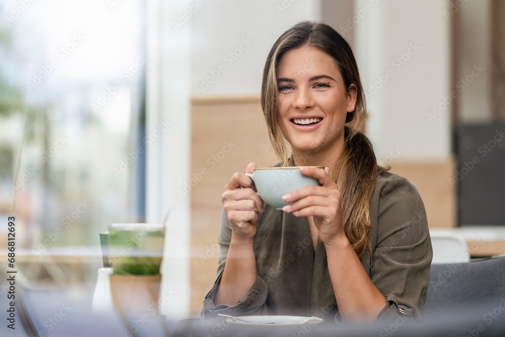 Young businesswoman with coffee cup in a cafe Young businesswoman with coffee cup in a cafe