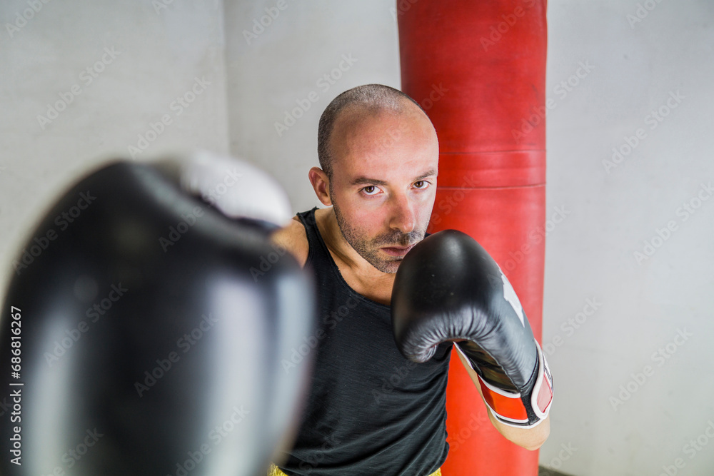 Portrait of boxer boxing in gym