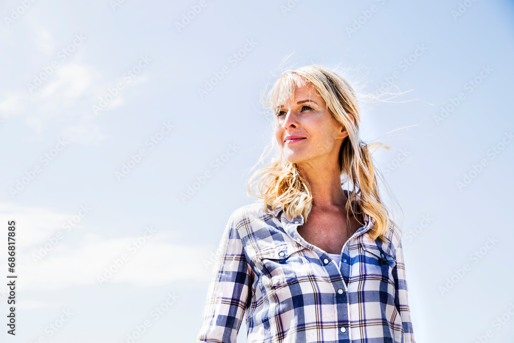Blond woman wearing checked shirt outdoors