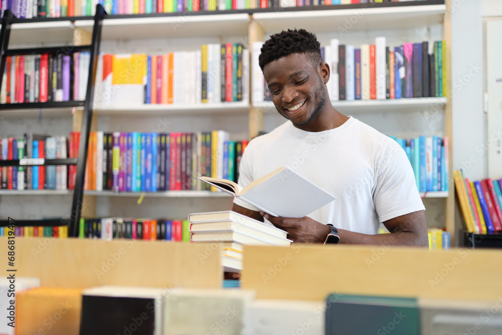 Joyful student in a university library, surrounded by books, showcasing intelligence and a love for learning. Joyful student in a university library, surrounded by books, showcasing intelligence and a love for learning.