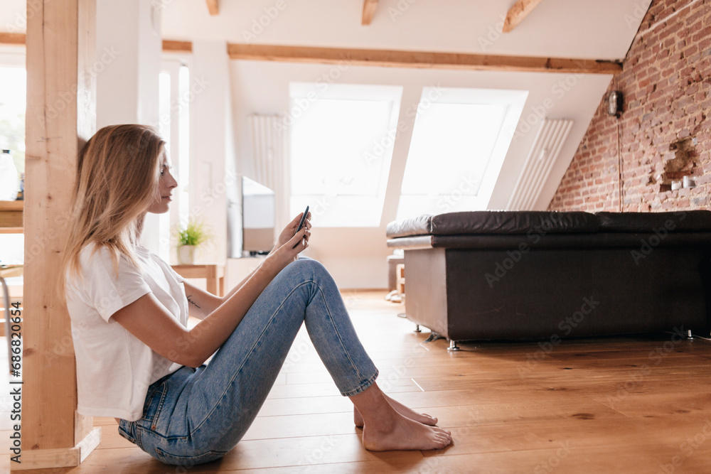 Young woman at home using smartphone Young woman at home using smartphone