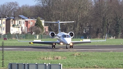 Business Private Corporate Executive Jet Taxiing and Turning off the Runway after landing at International Airport. photo