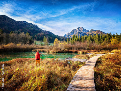 Slovenia, Kranjska Gora, Man photographing scenic landscape of Zelenci Springs