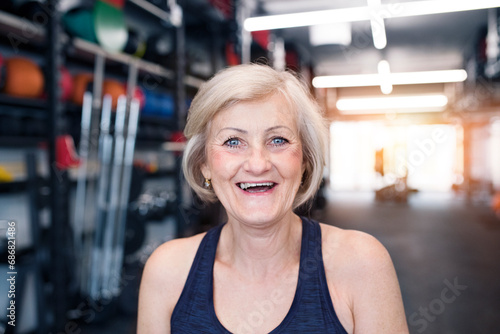 Portrait of happy senior woman in gym © tunedin
