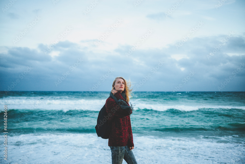 Young woman at the seashore in winter