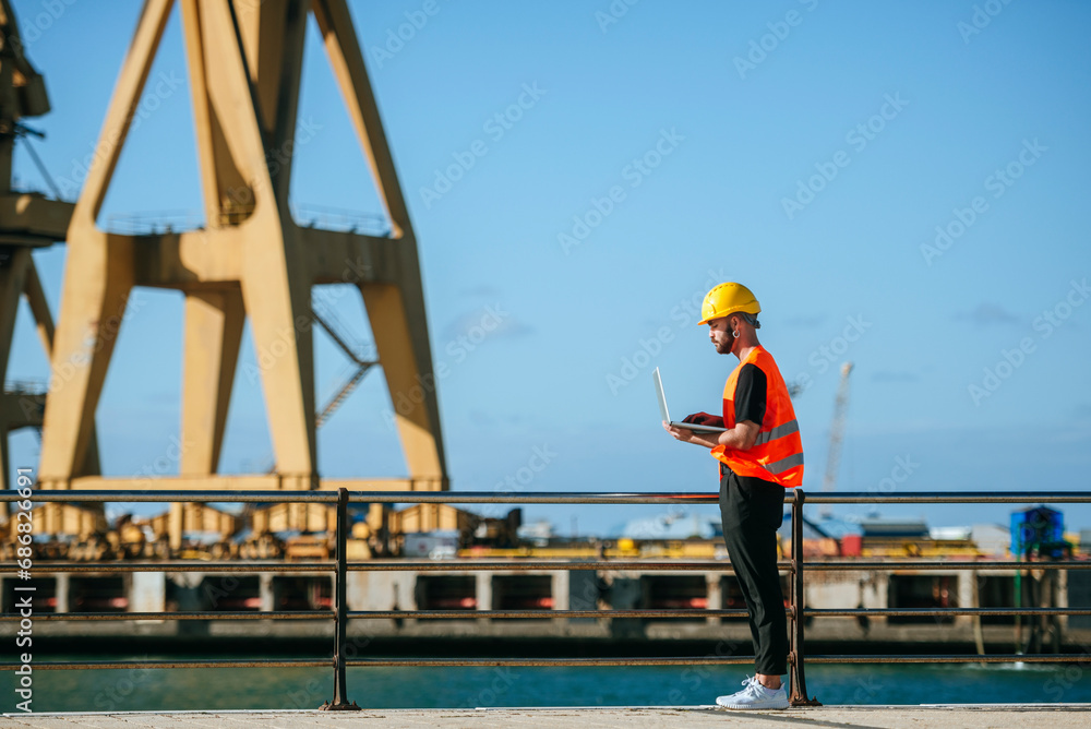 Port worker using a laptop at work