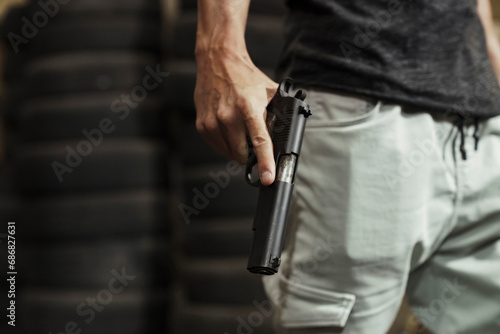 Close-up of man holding a pistol