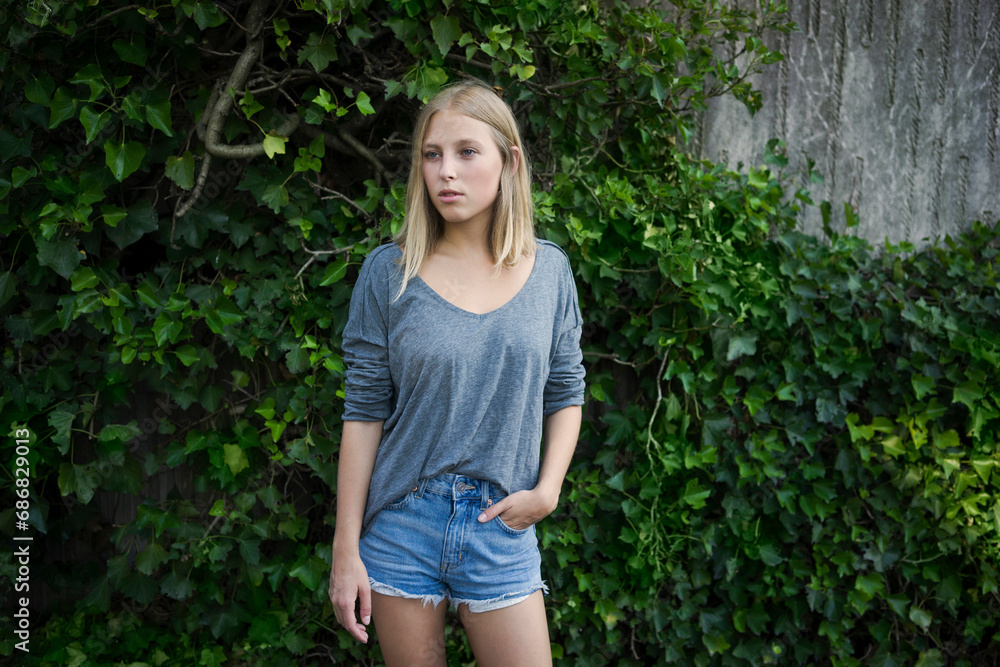 Portrait of blond young woman wearing jeans shorts Portrait of blond young woman wearing jeans shorts