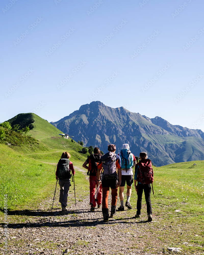 Group of hikers walking in the mountains, Orobie Mountains, Lecco, Italy