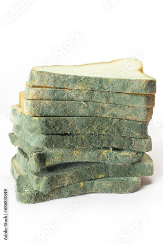 Green moldy bread isolated on a white background. photo