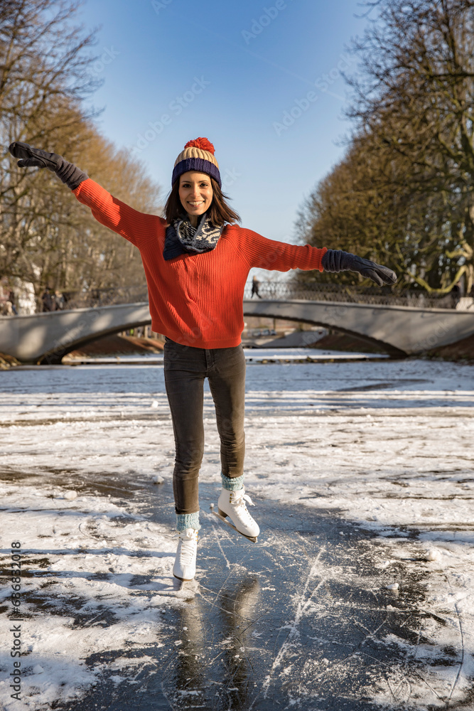 Woman ice skating on canal