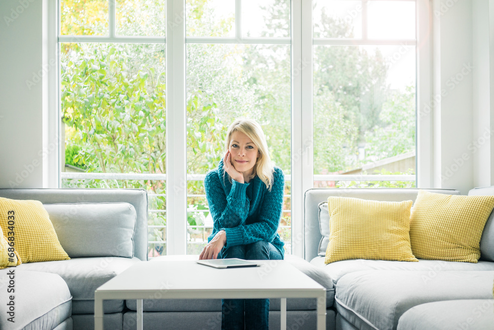 Portrait of smiling woman with tablet on couch Portrait of smiling woman with tablet on couch
