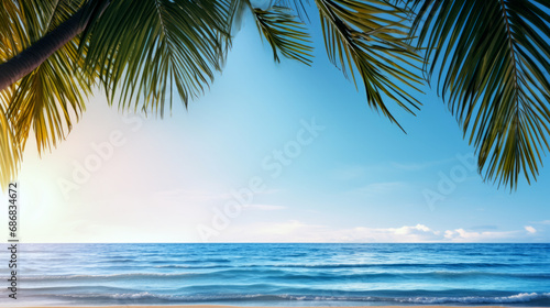 A view of a blue sky and sea with out-of-focus light and coconut palm tree leaves. Copy space, summer vacation concept.