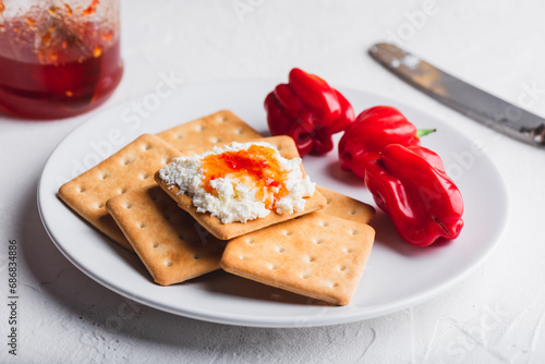 Habanero sauce with cream cheese on crackers