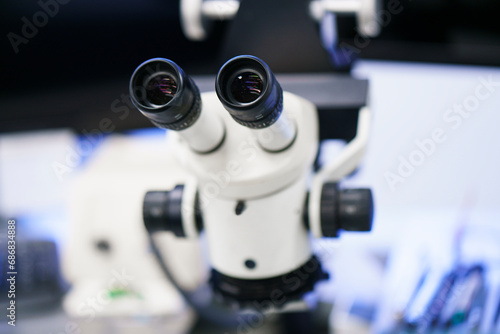 Close-up of white microscope at illuminated laboratory © tunedin