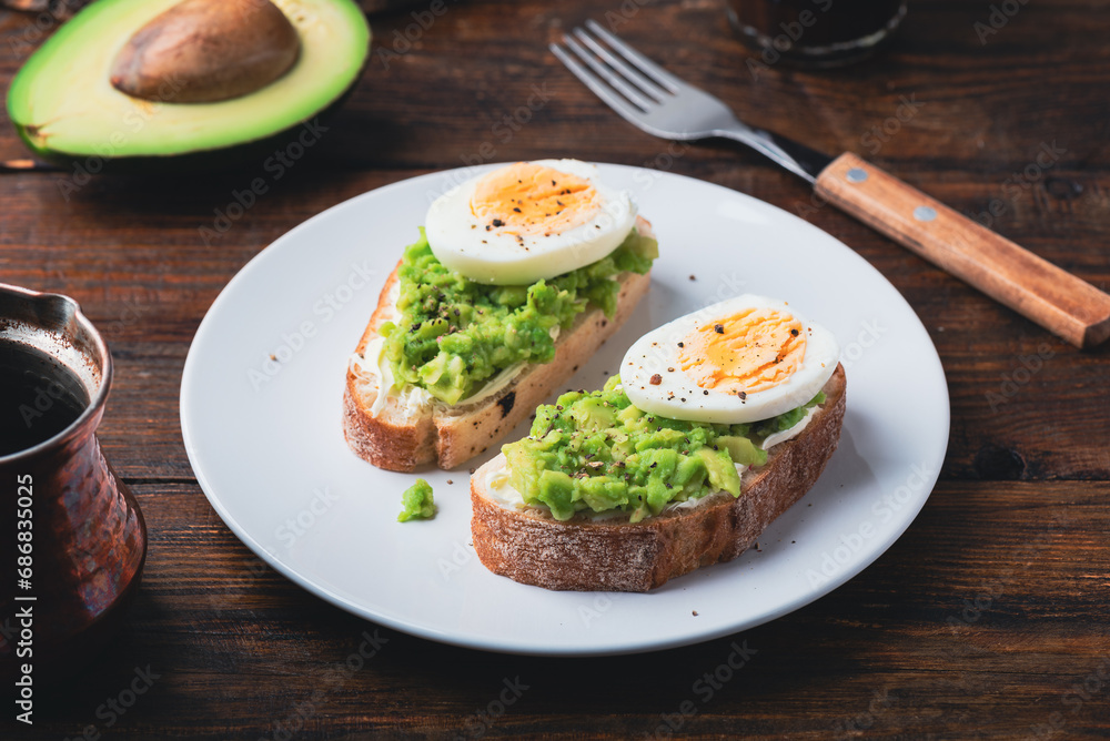 Toasts with mashed avocado, cream cheese and boiled egg