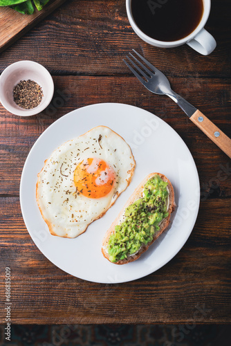 Toasts with mashed avocado and fried egg for breakfast