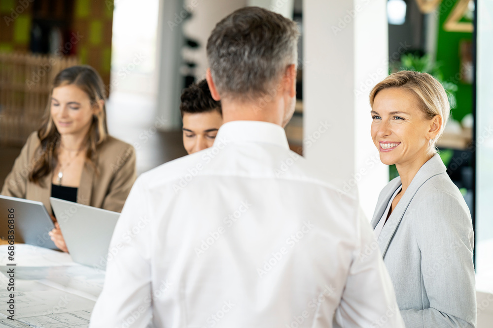 Senior businessman and woman leading workshop in office Senior businessman and woman leading workshop in office