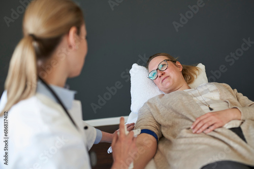 Female doctor preparing a blood sampling from patient in medical practice