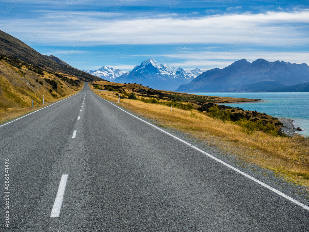 New Zealand, South Island, empty road with Aoraki Mount Cook and Lake Pukaki in the background