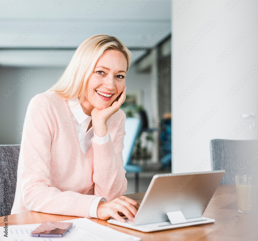 Portrait of smiling businesswoman using tablet in office Portrait of smiling businesswoman using tablet in office