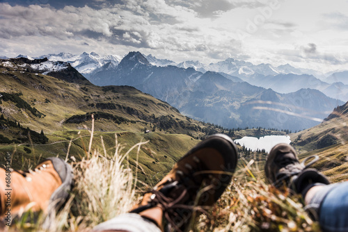 Germany, Bavaria, Oberstdorf, feet of two hikers resting in alpine scenery © tunedin