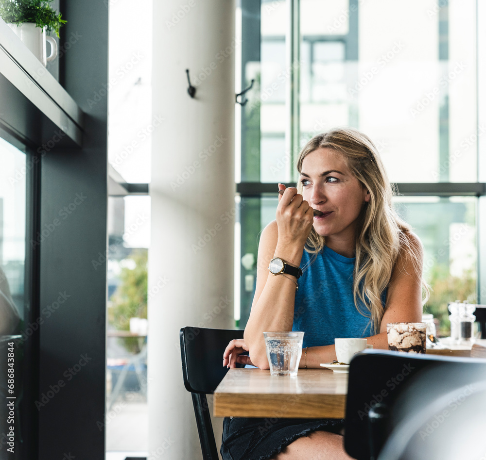 Young woman in cafe, drinking coffee and eating sweets Young woman in cafe, drinking coffee and eating sweets