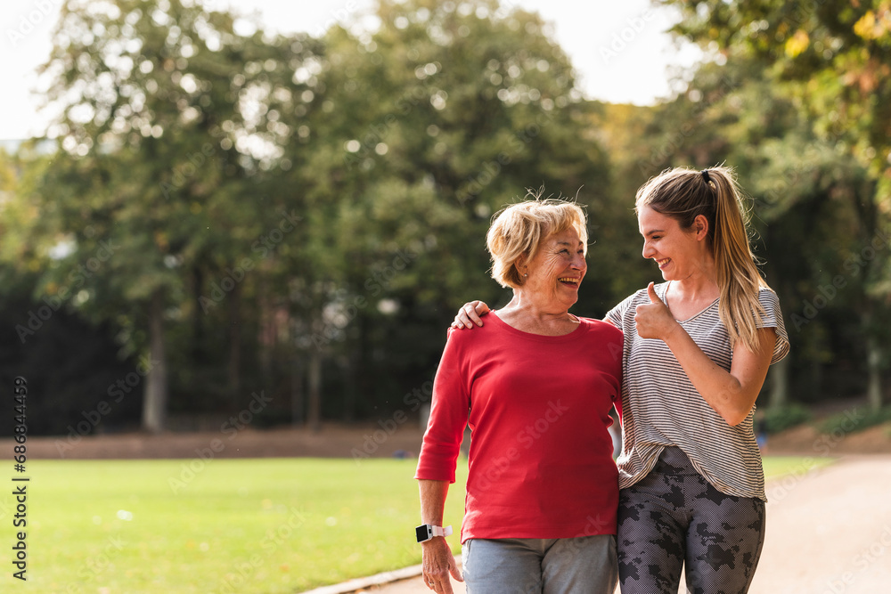 Granddaughter and grandmother having fun, jogging together in the park