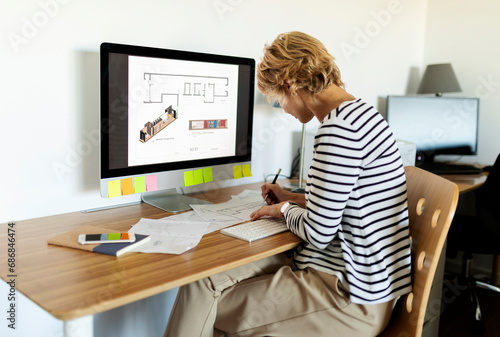 Female architect working on project in home office photo