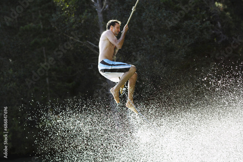 Man Swinging on Rope photo