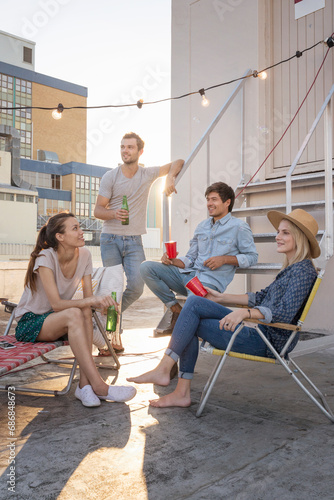 Friends having a rooftop party on a beautiful summer evening