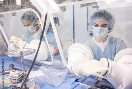 Scientists processing human tissue in insulator laboratory