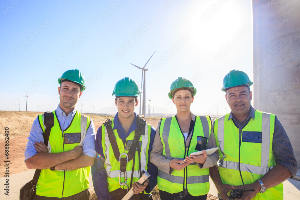 Portrait of four smiling engineers on a wind farm Portrait of four smiling engineers on a wind farm