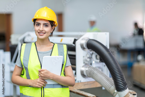 Portrait of smiling female technician with tablet photo